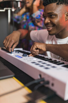 Black friends sharing laptop with recording program on screen