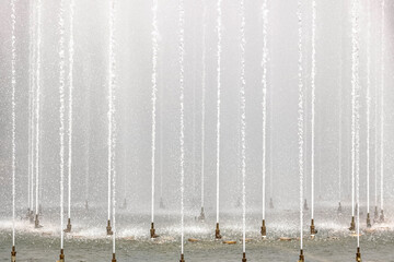 Background of jets and splashes of a fountain in the park