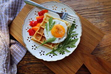 Healthy breakfast . Freshly made, delicious meal of eggs and vegetables. Gluten-free buckwheat waffles with fried eggs