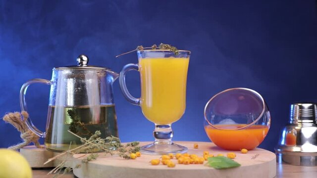 a composition of a hot cocktail with tea and  herbs