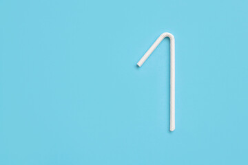 Biodegradable eco friendly white paper drinking straw on blue background