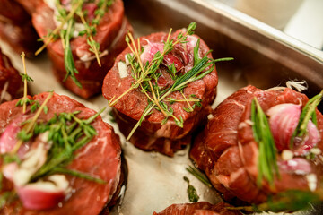 Close-up of raw meat steak with pepper and salt and sprigs of rosemary