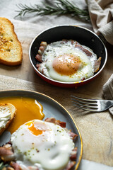 Breakfast with fried egg(sunny side up) with bacon, grilled with rosemary mushrooms and toast with cream cheese