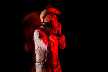 Astronaut in space suit standing in red neon light