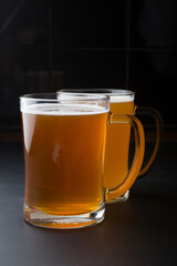 Glass of lager beer served on a black