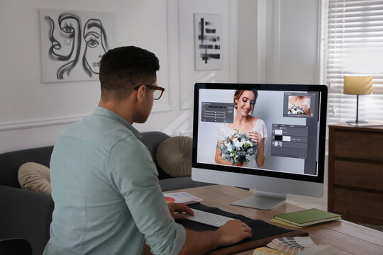 Professional retoucher working on computer in office