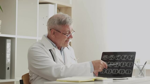 doctor shows an X-ray or ultrasound scan and tells diagnosis