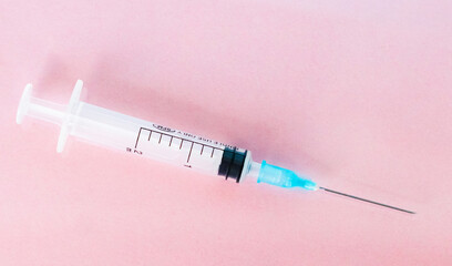 Syringe isolated on pink background. Close-up of a syringe. Syringe injection.