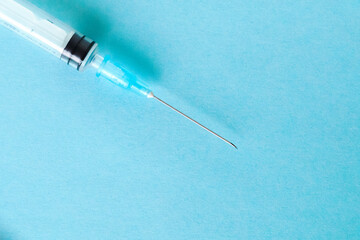 Syringe isolated on a blue background. Syringe close-up. A shot in a syringe.