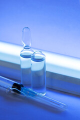 Syringe and ampoules close up. Medicines for injection and a germicidal lamp.