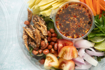 Spicy fresh mango salad in box. Thai street food