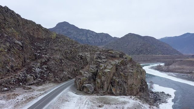 Aerial footage of scenery road among rocks. Artificial road Chuiskiy trakt at Altai Republic