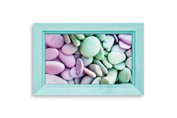 Photo frame with colorful sea stones picture isolated on white wall, light green color design