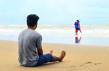 Young couple spending time together on the beach. Romantic newlyweds couple on the beach.