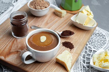 Healthy clean food concept, keto, ketogenic diet, morning breakfast table. Brewed bulletproof coffee with organic coconut oil, ghee and coffee beans. Cozy cafe atmosphere
