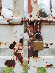 Padlock on the rustic metal gate.