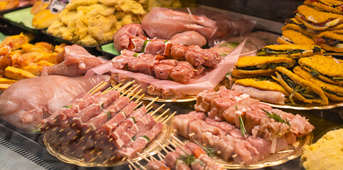 Showcase with raw farmer meat in butcher shop