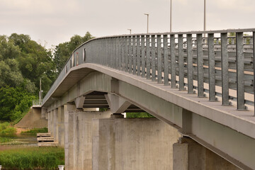 Bridge over the river on a cloudy day. Summer. Day.