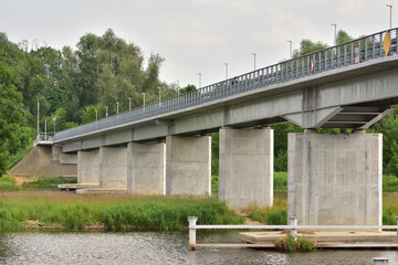 Bridge over the river on a cloudy day. Summer. Day.