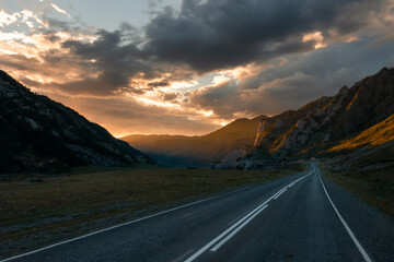 road in mountains valley and storm clouds on a dark sky © Detkov D