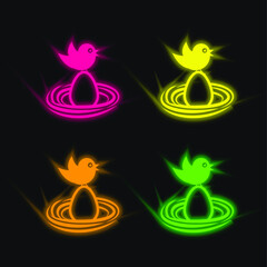 Bird On An Egg In A Nest four color glowing neon vector icon