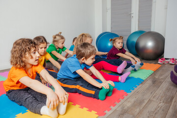 Children exercising while physical education lesson at preschool