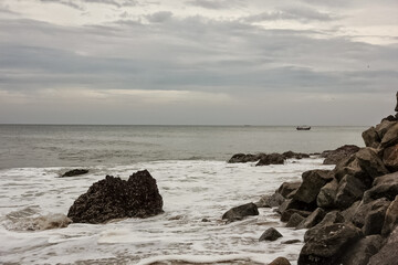 Rocky boulders and crags along the sea in the coastal village of Varkala in Kerala, India.