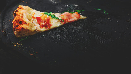 last slice of pizza on black wooden board in cafe