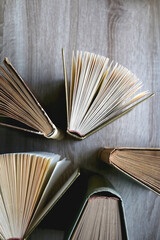 Vintage hardcover books on a wooden table. Top view.
