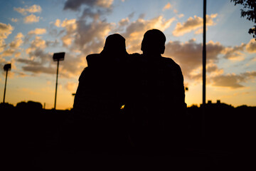 Silhouette of a couple back at sunset