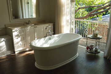 General view of luxury sunny bathroom with bathtub in the middle - Powered by Adobe