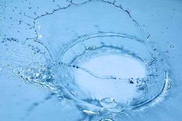 Transparent blue colored clear water surface texture with ripples, splashes and bubbles. Nature...
