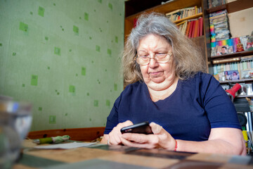 Serious Elderly Jewish Overweight Lady at Home Typing on the Phone