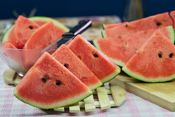 slices of watermelon on wooden plate