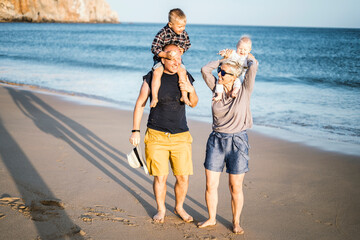 The family with two small boys enjoying time on the beach in Portugal