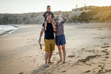 The family with two small boys enjoying time on the beach in Portugal