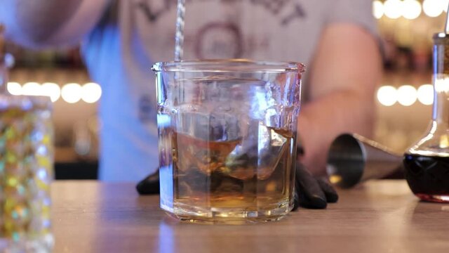 a man mixes the drink from the glass