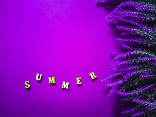 Creative mockup made of lavender flowers and wooden lettering “summer”. Summer concept with...