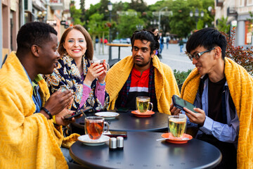 Multiracial group of friends having a drink together