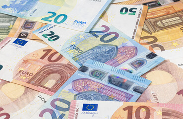 A big pile of euro banknotes. Many Euro bills lie on top of each other. Bunch of money of the European Union. Currency of the united Europe. Cash balance of the European Central Bank or ECB.