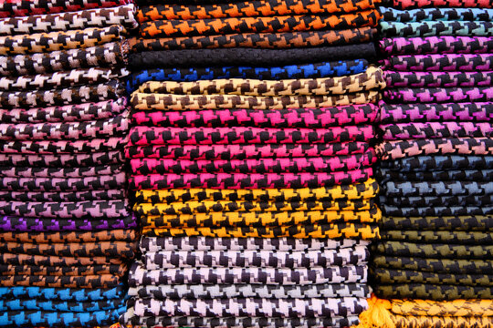 Folded colorful keffiyehs or kufiyas at middle eastern bazaar. Traditional Middle Eastern headdress fashioned from a square scarf, and is usually made of cotton