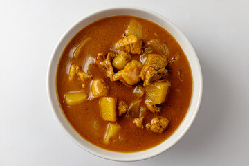 Curry with spices on a white background