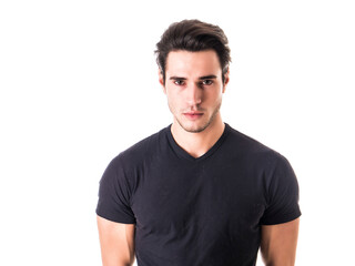 Handsome young man looking at camera in studio