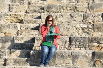 Young Woman Sitting in Ancient Greek Theater Watching a Tragedy, Kourion, Cyprus