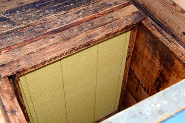 Wax foundation in frames in old wooden hive.