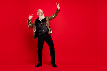 Full length photo of funky beard elder man dance wear gold jacket pants isolated on red color...