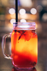 Christmas drink red non-alcoholic mulled wine with a straw on the background of the cafe interior, order for one