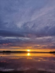 Sunset on the river with cloudy sky. Nature background. Outdoors rural slow life
