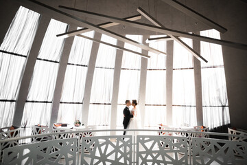 Gorgeous happy couple standing close to each other and looking in eyes