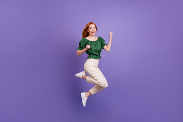 Full length profile side photo of young girl happy positive smile rejoice victory success jump isolated over violet color background